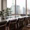 Modern office boardroom city skyline views sleek chairs indoor plants