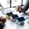 Real estate agents explain models of housing estates in projects to elaborate to clients, explaining and presenting information about homes and purchasing loans. Real estate trading concept.