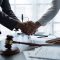 The handshake after a good cooperation, consulting between attorney and client, businessman, tax and real estate project company. Law and justice concept